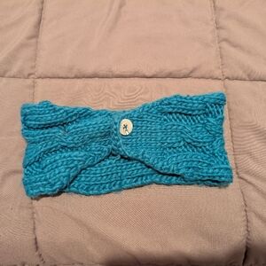 Knitted cold weather headband with button clasp